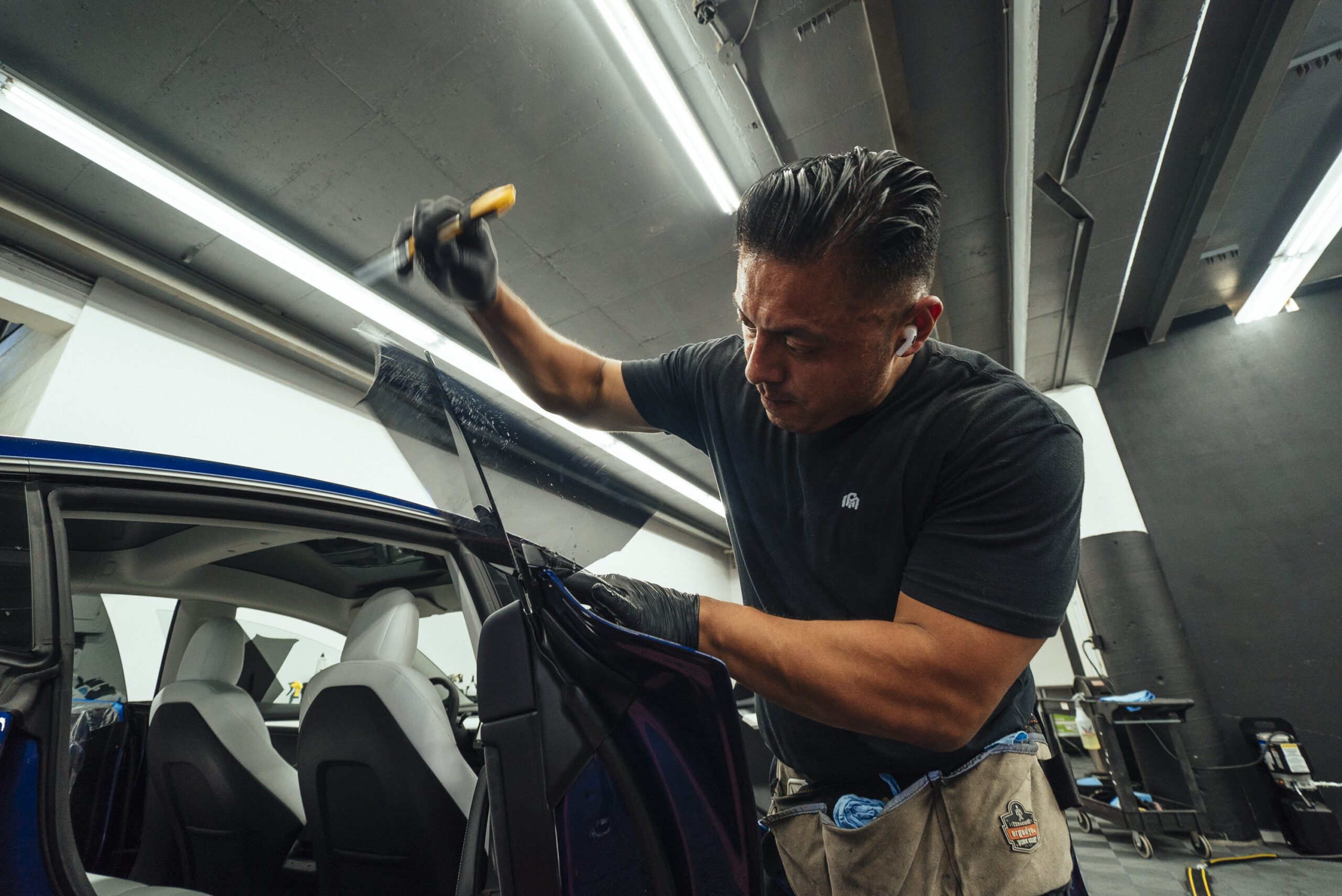 Polished Protection technician performing a window tint installation